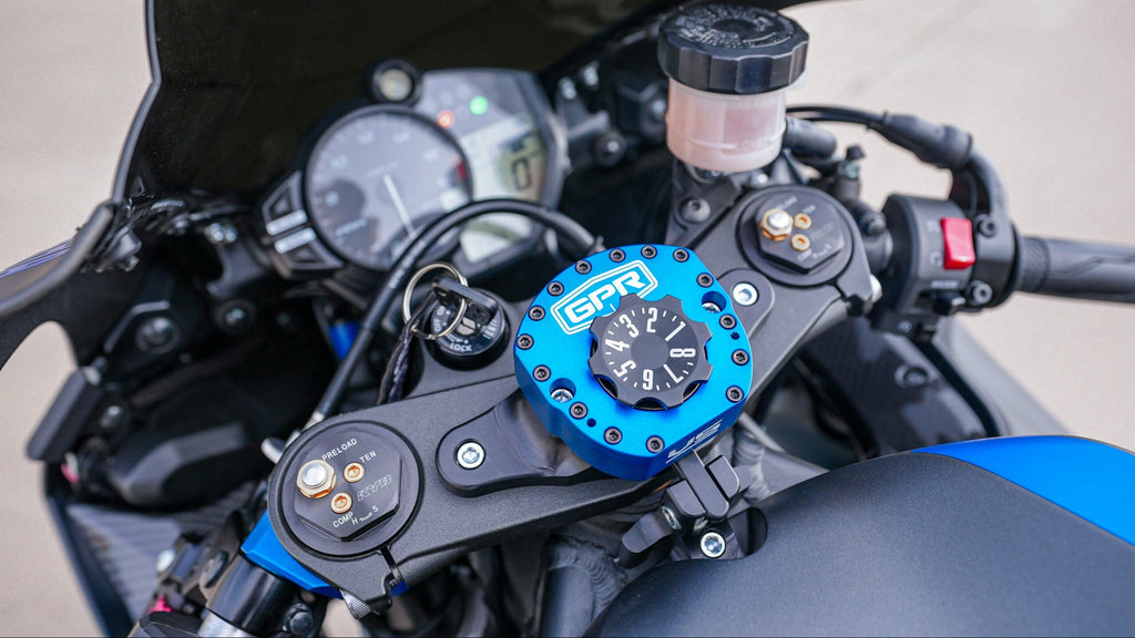 Close-up of a motorcycle dashboard with a blue GPR unit.