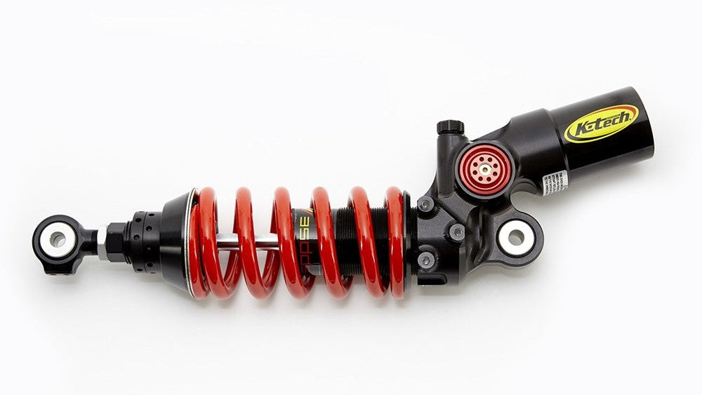 Motorcycle shock absorber with red spring on a white background