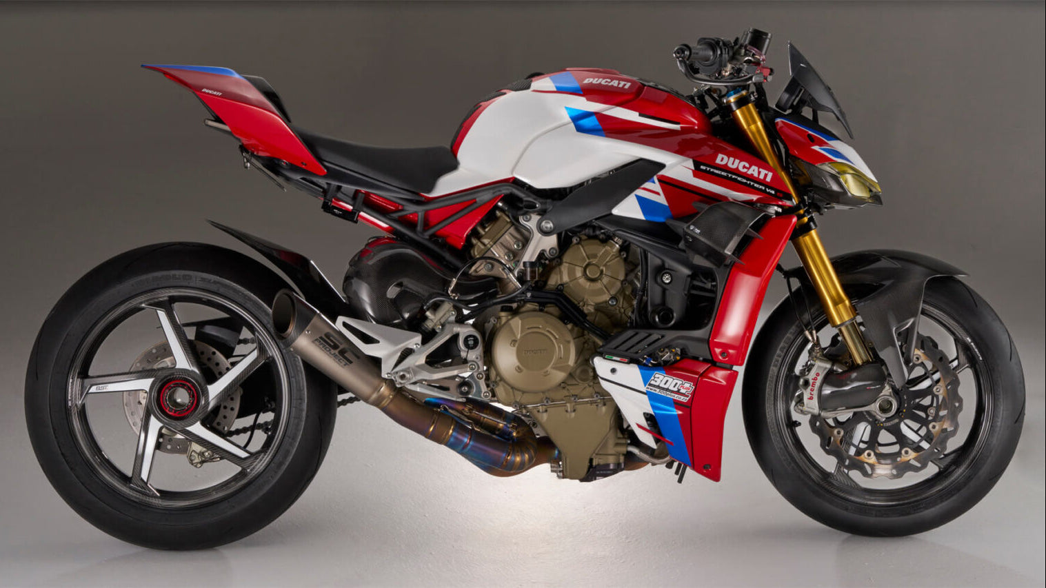 Red and white Ducati motorcycle on a gray background