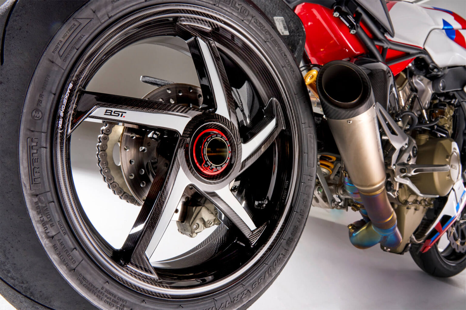 Close-up of a motorcycle wheel with visible branding on a white background