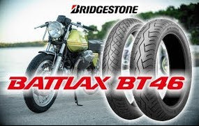 Two Bridgestone Battiax BT46 tires with a motorcycle in the background.