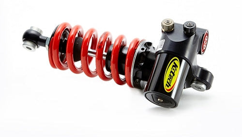 Motorcycle shock absorber with red spring and black metal housing on a white background