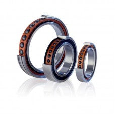 Three metallic bearings of different sizes on a white background