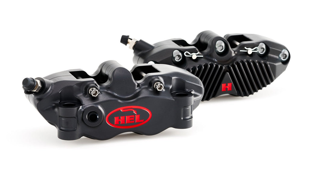 Two black brake calipers with a red HEI logo on a white background