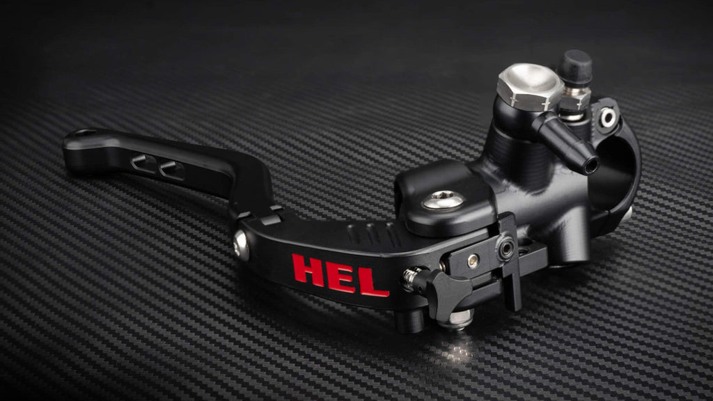 Black motorcycle brake lever with 'HEL' branding on a carbon fiber background